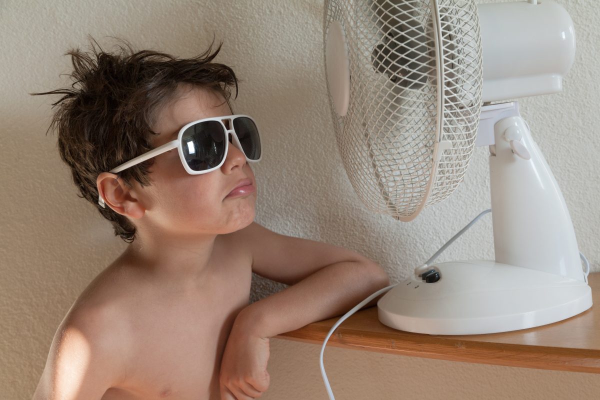 Boy,cools,with,a,fan,,portrait