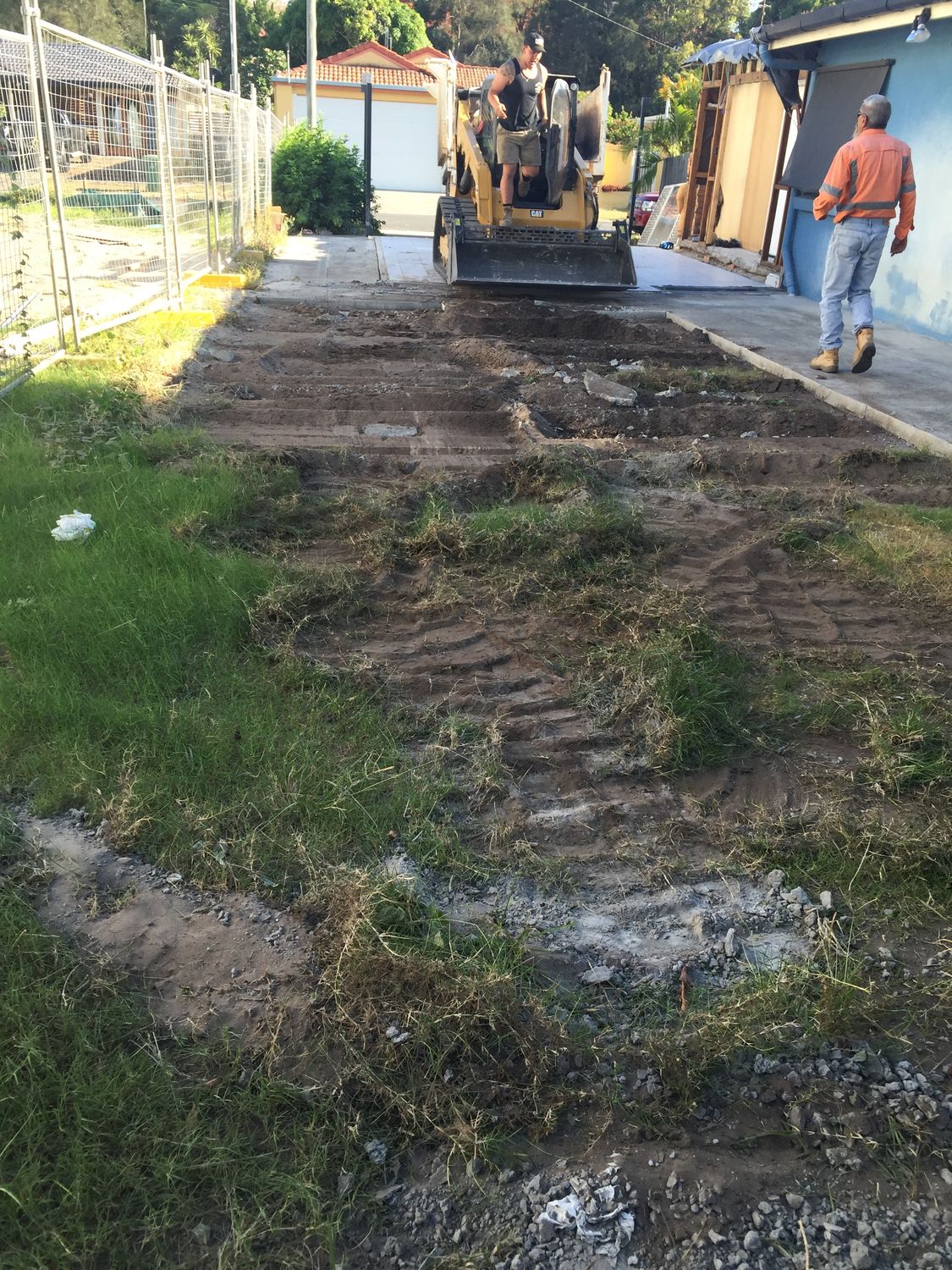 Excavator and worker on site during earthworks for pool and foundation construction at Southport Gold Coast renovation